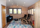 Living room from dining. Murphy bed at right, closet door at left.