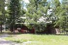 Cabin and open space with trees from street