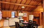 Kitchen and Dining - Table seats six. Bar counter to left has 2 bar stools.